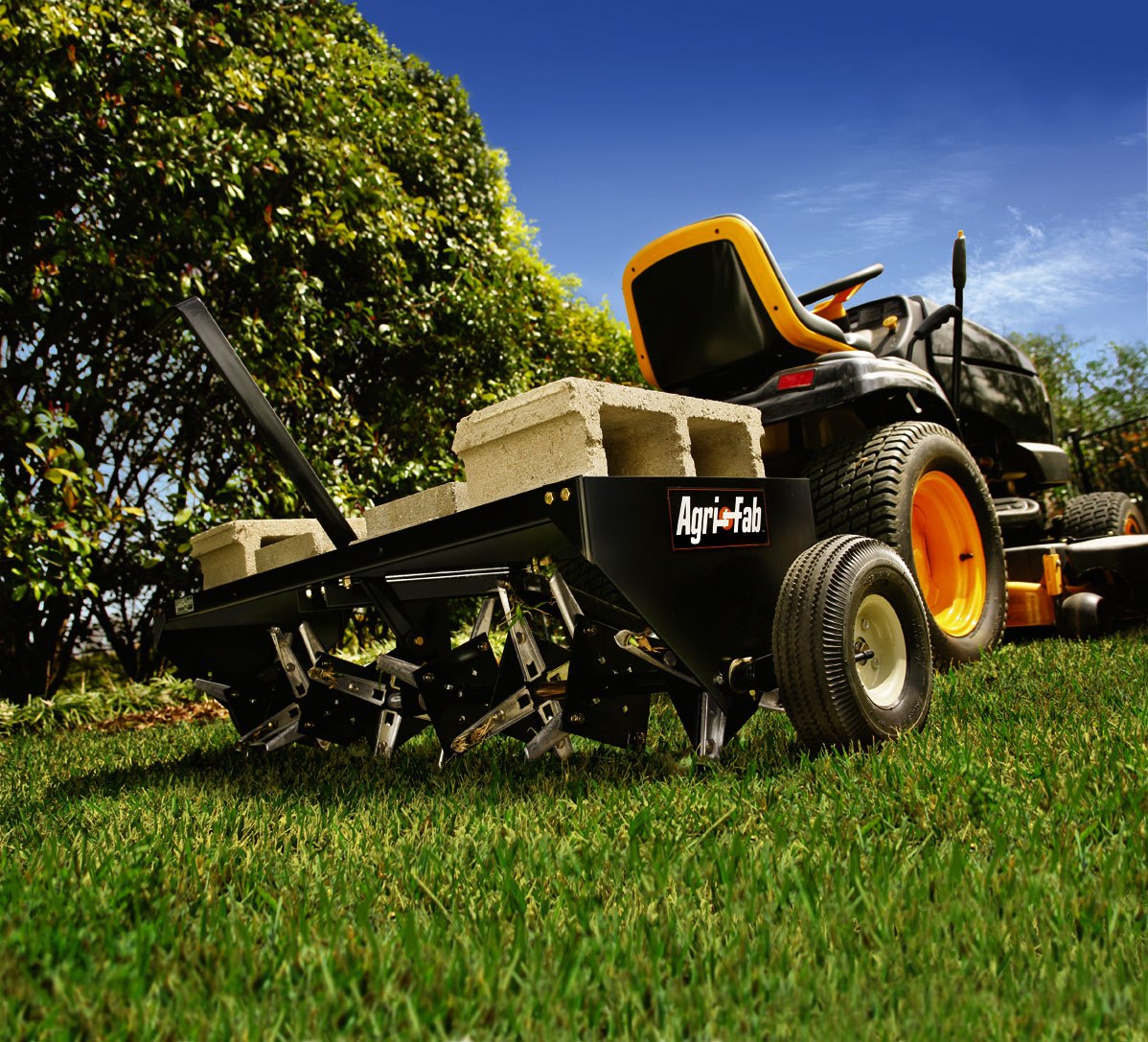Illustrative photograph of a tow-behind core aerator on a lawn